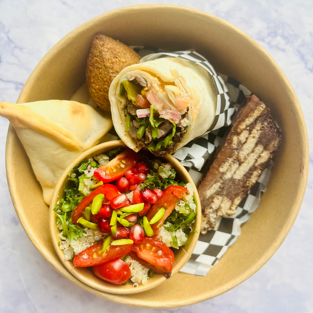Lunchbox with a salad, shawarma wrap, spinach fatayer and kibbeh